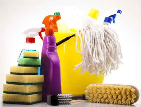 Professional cleaner treating fabric chairs in Docklands home